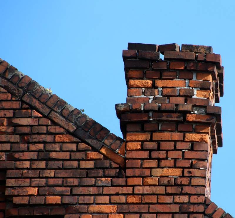 Signs Your Frederick Home Needs a Chimney Inspection Damaged chimney on an Frederick home showing cracks and missing mortar